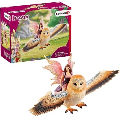 Brinquedo de fada cor-de-rosa montada numa coruja voadora castanha e caixa colorida