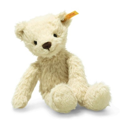 Ursinho de peluche creme claro com etiqueta amarela na orelha