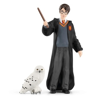 Figura de ação de Harry Potter com varinha e coruja branca.