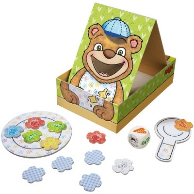 Conjunto de jogo infantil com tabuleiro de papelão e peças coloridas em forma de flor.