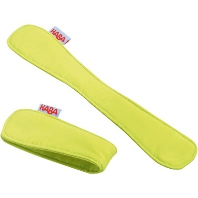 Dois protetores de tecido amarelo claro com etiqueta HABA em fundo branco.