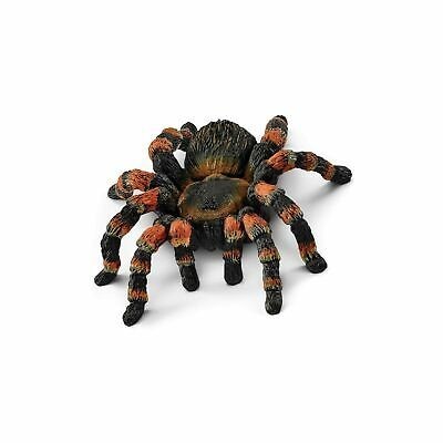 Figura decorativa de aranha tarântula preta e laranja sobre fundo branco