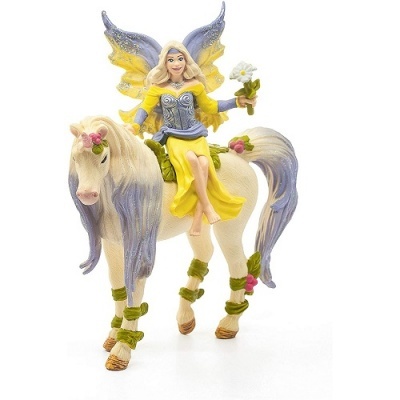 Figura de fada com asas em cavalo branco com crina lilás