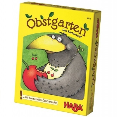 Caixa amarela do jogo de cartas Obstgarten com um cuervo e uma cereja ilustrados