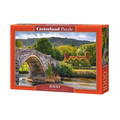 Caixa de quebra-cabeças com imagem de vila rural em Gales com ponte de pedra e casa com telhado verde