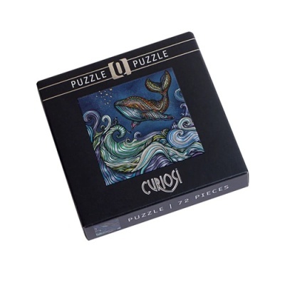 Caixa preta de puzzle com imagem de baleia e ondas coloridas