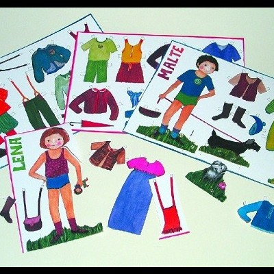 Folhas com bonecos de papel recortáveis e roupas coloridas ao redor