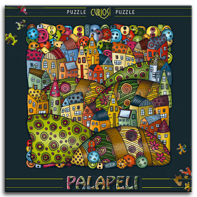 Caixa de puzzle com imagem colorida de vila e padrão circular com texto PUZZLE CURIOSI PUZZLE PALAPELI