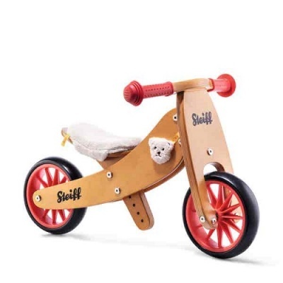Bicicleta de equilíbrio infantil em madeira com detalhes vermelhos e urso de peluche