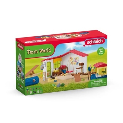 Caixa de brinquedo Schleich Farm World com cenário de quinta e figuras em plástico.