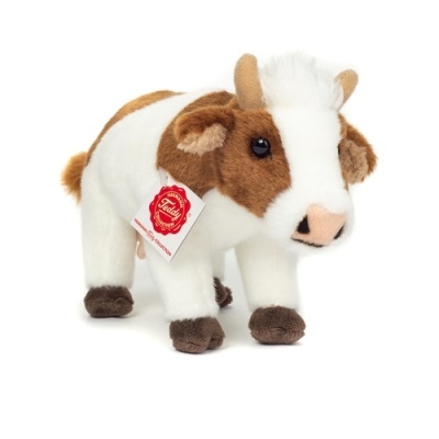 Pelúcia de vaca castanha e branca com etiqueta vermelha na orelha