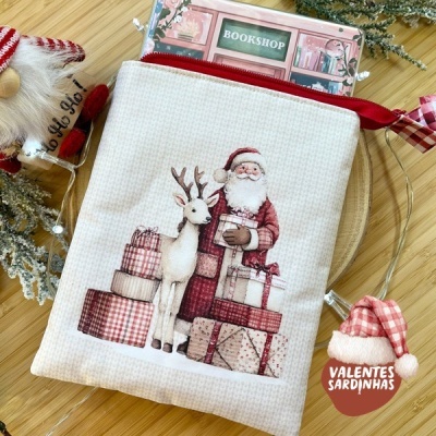 Necessaire de tecido bege com estampa de Pai Natal, rena e presentes.