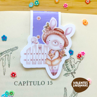 Adesivo de coelho vestido com roupa castanha em página de livro