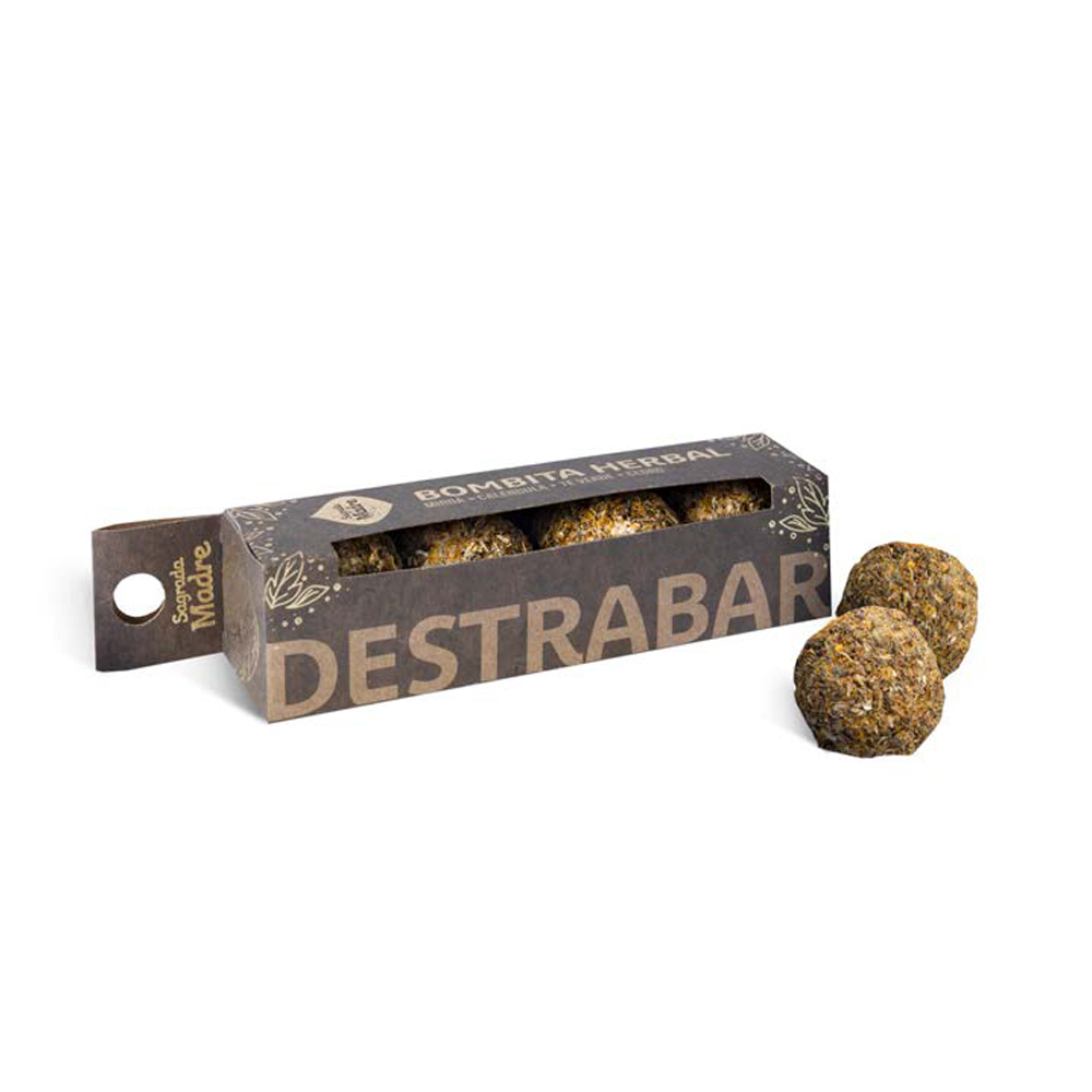 Bombitas Herbal Sagrada Madre - Desbloqueio Embalagem castanha com bolinhas esverdeadas e duas bolinhas soltas ao lado