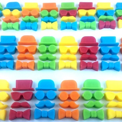 Peças coloridas de borracha com formas de personagens alinhadas