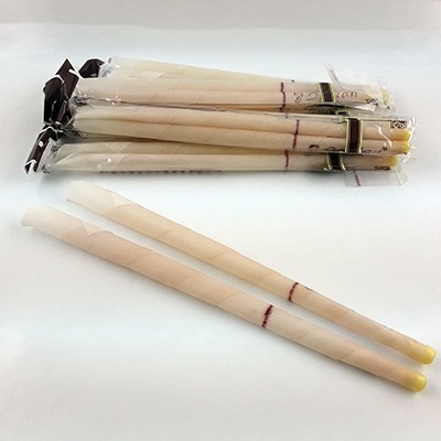 Velas finas brancas com pontas amarelas e linhas castanhas em sacos transparentes