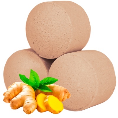 Três comprimidos bege claro com gengibre e folhas verdes