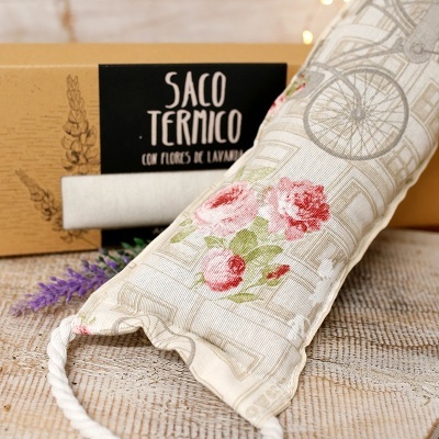 Saco térmico com padrão floral e embalagem com etiqueta preta em superfície têxtil clara