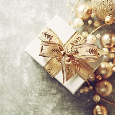 Caixa de presente branca com fita dourada e decorações natalinas douradas