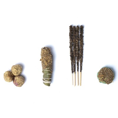 Produtos naturais variados, incluindo bolas vegetais, charuto ou incenso enrolado e incensos finos em palitos.