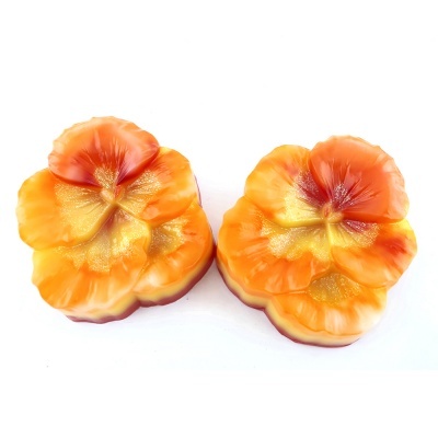 Sabonetes em forma de flores coloridas em tons de laranja e amarelo.