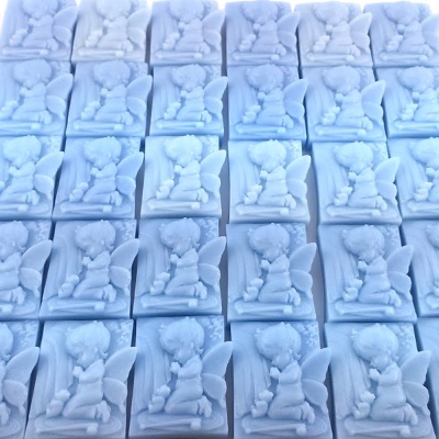 Esculturas brancas de anjinhos ajoelhados em base retangular alinhadas em filas