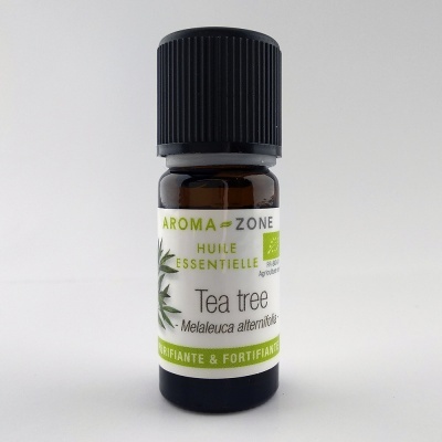 Frasco pequeno de óleo essencial de Tea tree Aroma Zone com tampa preta e rótulo branco e verde