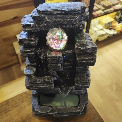 Fonte decorativa preto com cristal colorido e água a fluir