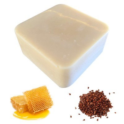Sabonete bege quadrado com favo de mel e grãos castanhos ao lado