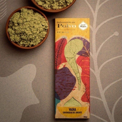 Embalagem colorida de sahumerio em pó ao lado de tigelas de cerâmica com pó verde.