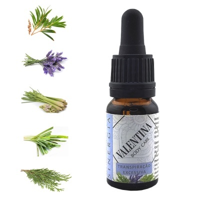 Frasco com conta-gotas e rótulo lilás ao lado de ervas frescas.