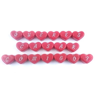 Corações vermelhos com letras brancas formando a frase 'QUERES CASAR COMIGO?'