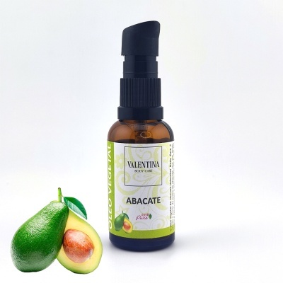 Frasco de óleo vegetal de abacate da Valentina Body Care com abacate cortado ao lado