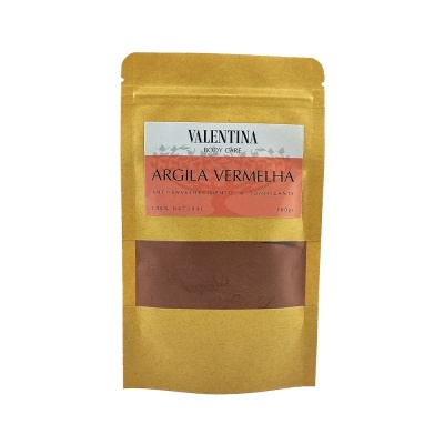 Embalagem dourada com produto de argila vermelha em pó