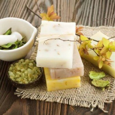 barras de sabonete artesanal com sais de banho e decoração natural sobre mesa de madeira