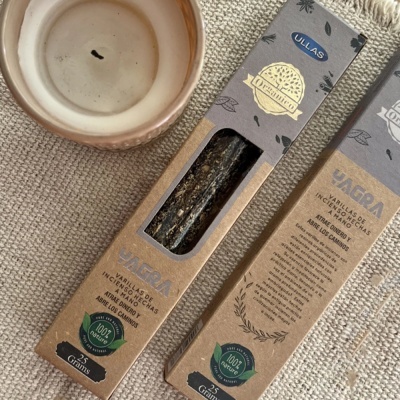 Caixas de incenso YAGRA e castiçal com vela usada em superfície têxtil