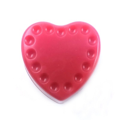 Massa de modelar vermelha em formato de coração com cavidades pontilhadas.