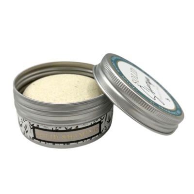 Recipiente metálico com shampoo sólido creme e tampa aberta