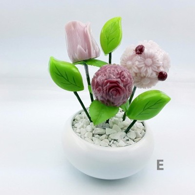 Vaso branco com flores decorativas rosas e folhas verdes