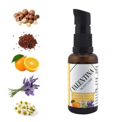 Frasco de óleo para bebés Valentina Body Care com ingredientes naturais ao lado