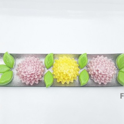 Prato decorativo com flores rosas e amarelas e folhas verdes