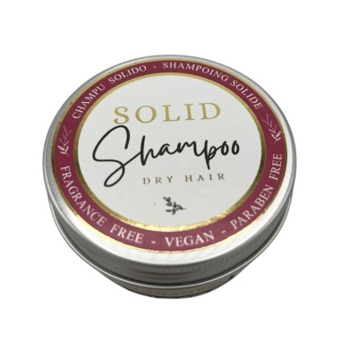 Embalagem de champô sólido para cabelo seco em lata metálica redonda, com tampa branca e borda vinho