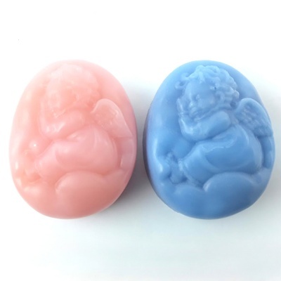 Sabonetes em forma oval com relevo de anjos, um rosa e um azul