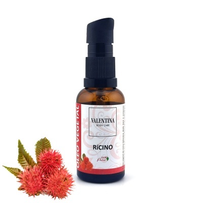 Frasco de óleo vegetal de rícino com doseador preto e flores vermelhas ao lado