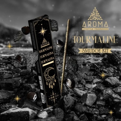 Kit de incenso preto com decoração dourada e texto TOURMALINE SMUDGE KIT em ambiente rochoso escuro