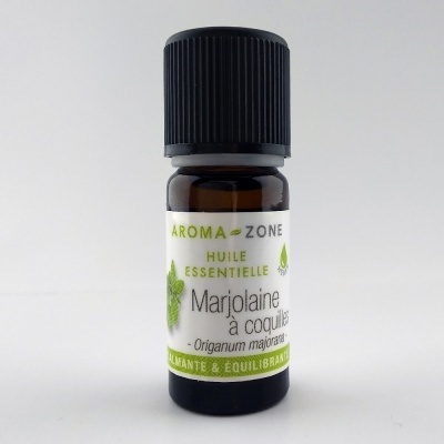 Frasco pequeno de óleo essencial com etiqueta branca e texto verde e preto