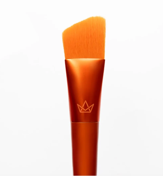 Pincel de maquilhagem com cerdas e cabo laranja e símbolo de coroa