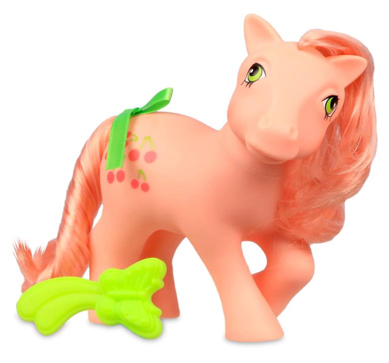 Cavalo de brinquedo cor-de-rosa com crina laranja e acessórios verdes