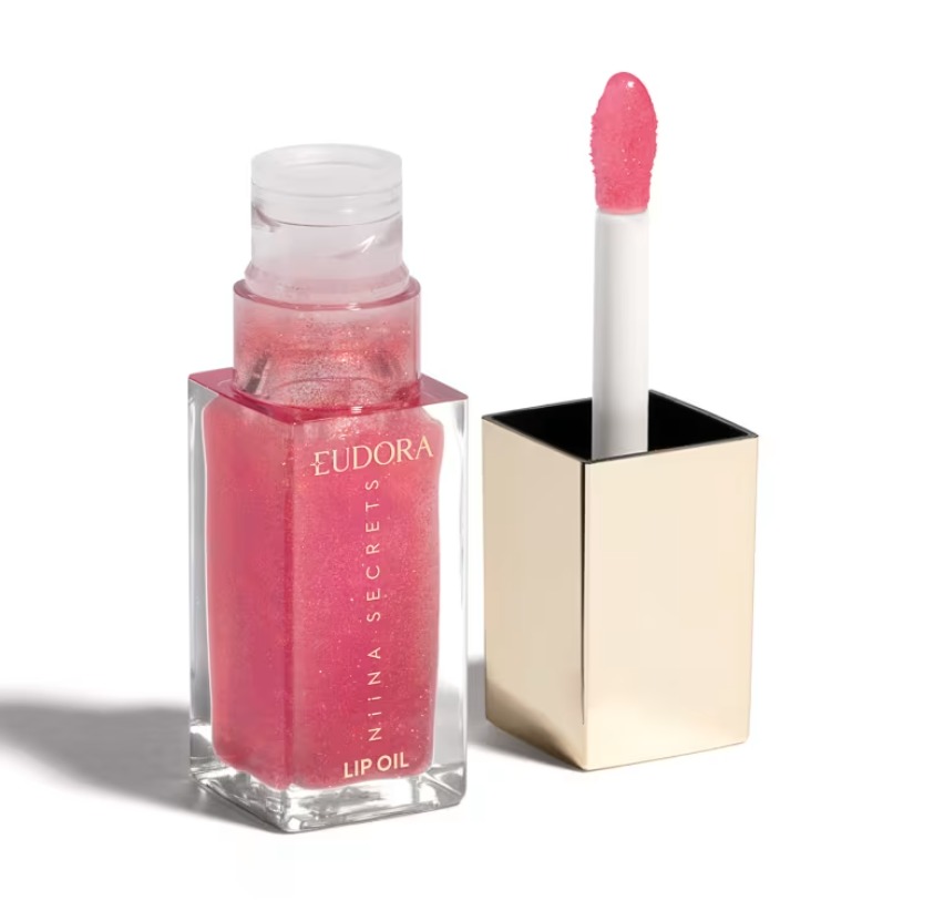 Frasco transparente de óleo labial rosa com brilho e texto EUDORA NIINA SECRETS LIP OIL