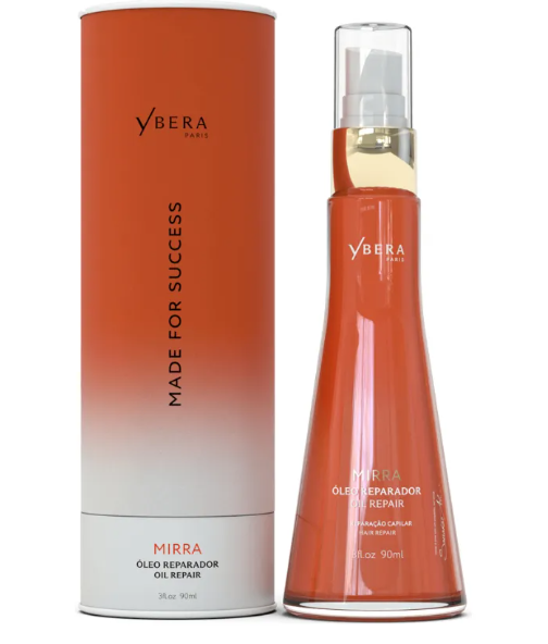 Frasco e caixa cilíndrica de óleo reparador Ybera Paris em tons laranja e branco.